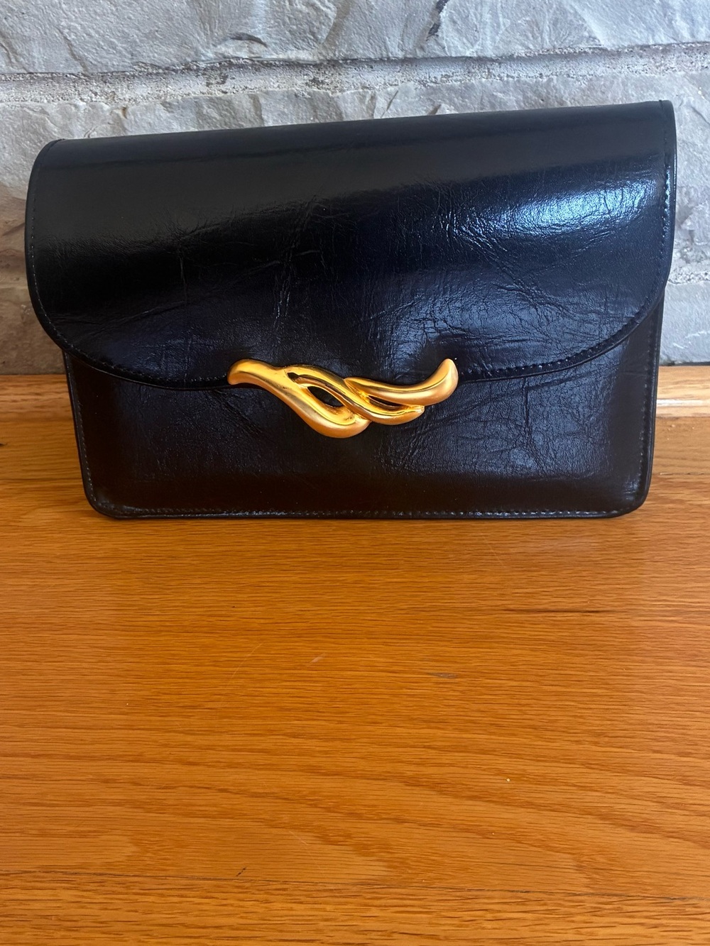 Black Faux-Leather Clutch with Gold Sculptural Hardware